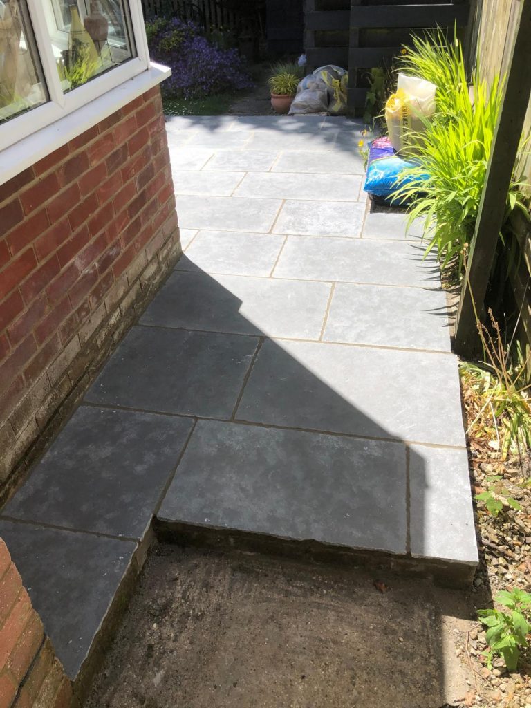 Grey cathedral limestone flagstone patio installation with step detail in Dorset