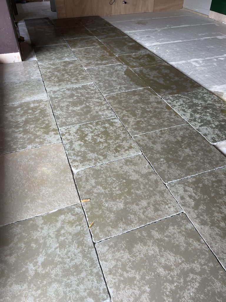 Cathedral limestone open plan flooring installation before grouting in Frome home