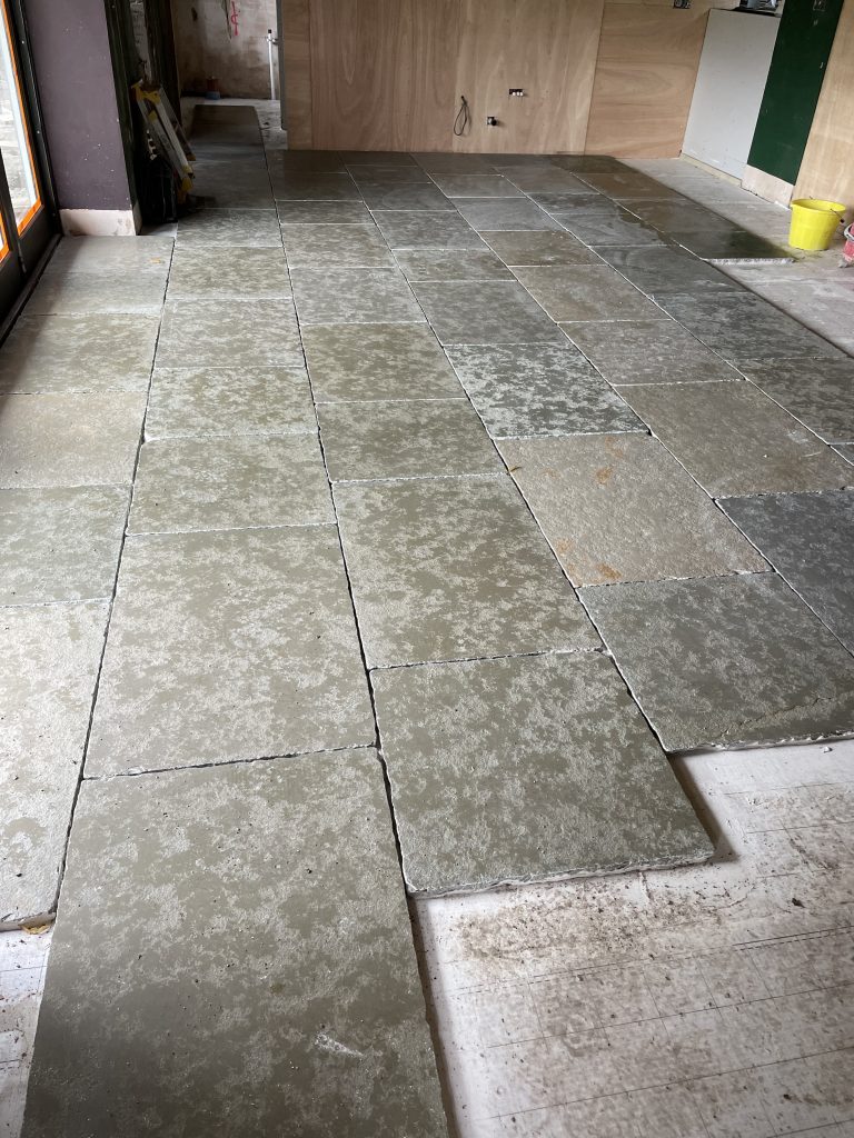Cathedral limestone 22mm flagstone laid in large open plan room prior to sealing