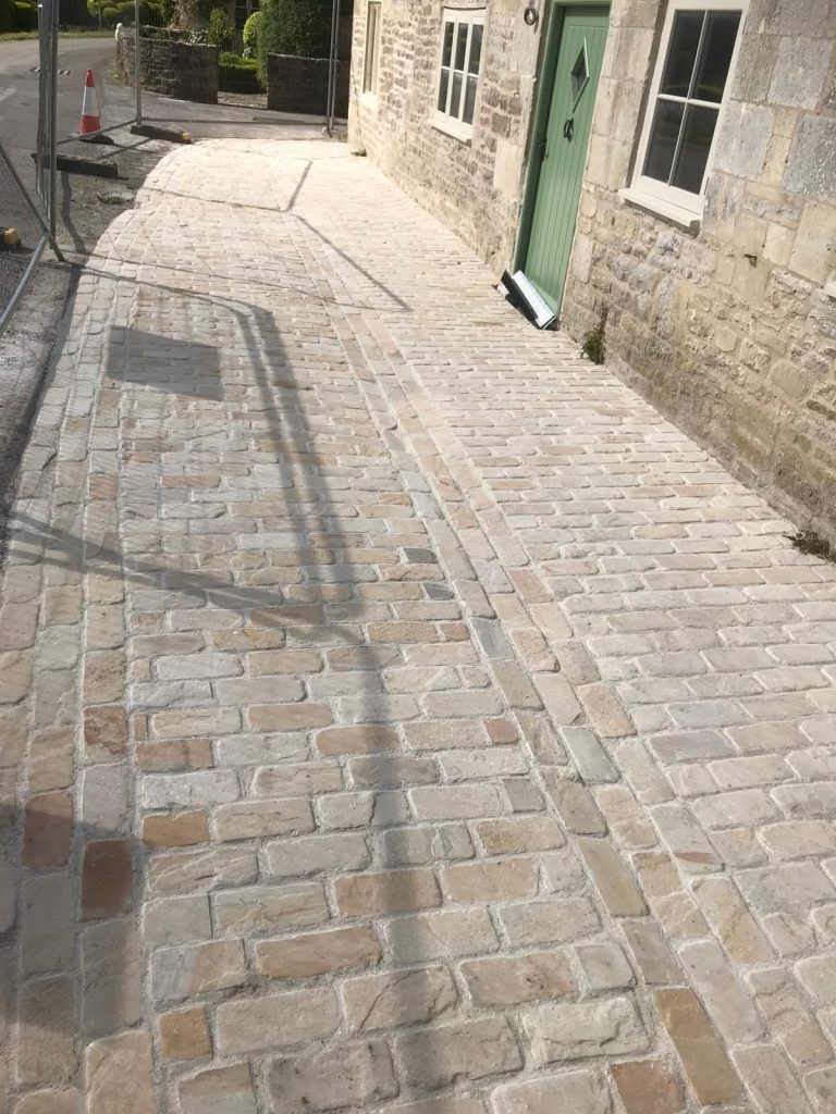 Cathedral limestone pavers in a courtyard installed by Simali Stone in Dorset