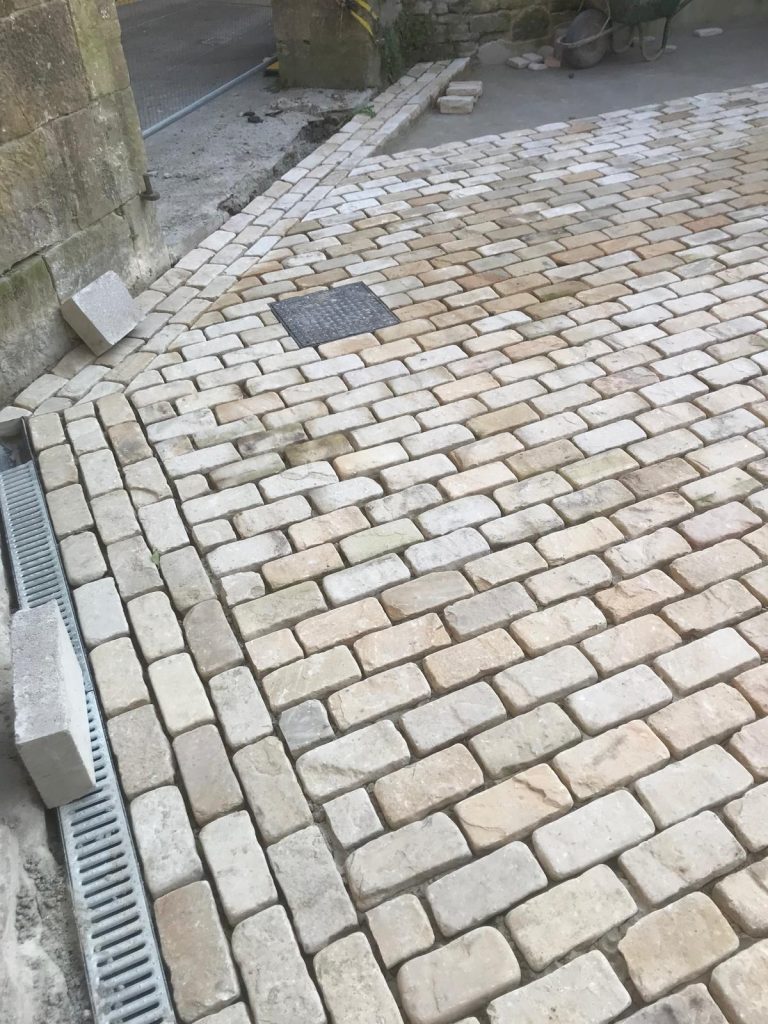 Part finished, ungrouted courtyard Cathedral pavers.
