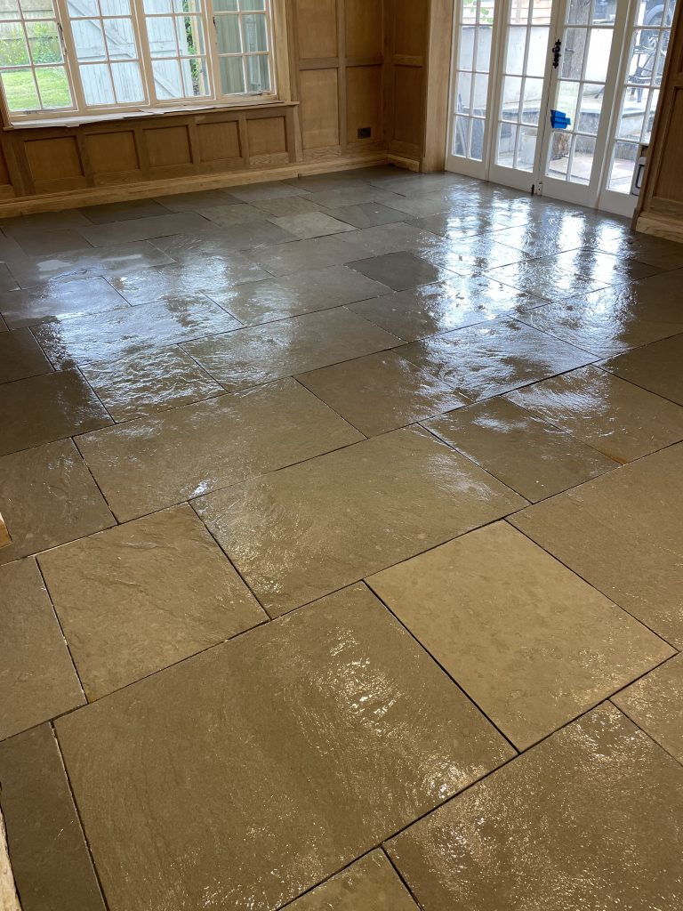 Ludlow Limestone kitchen floor, pre grout showing sealer drying on the riven and honed surface.