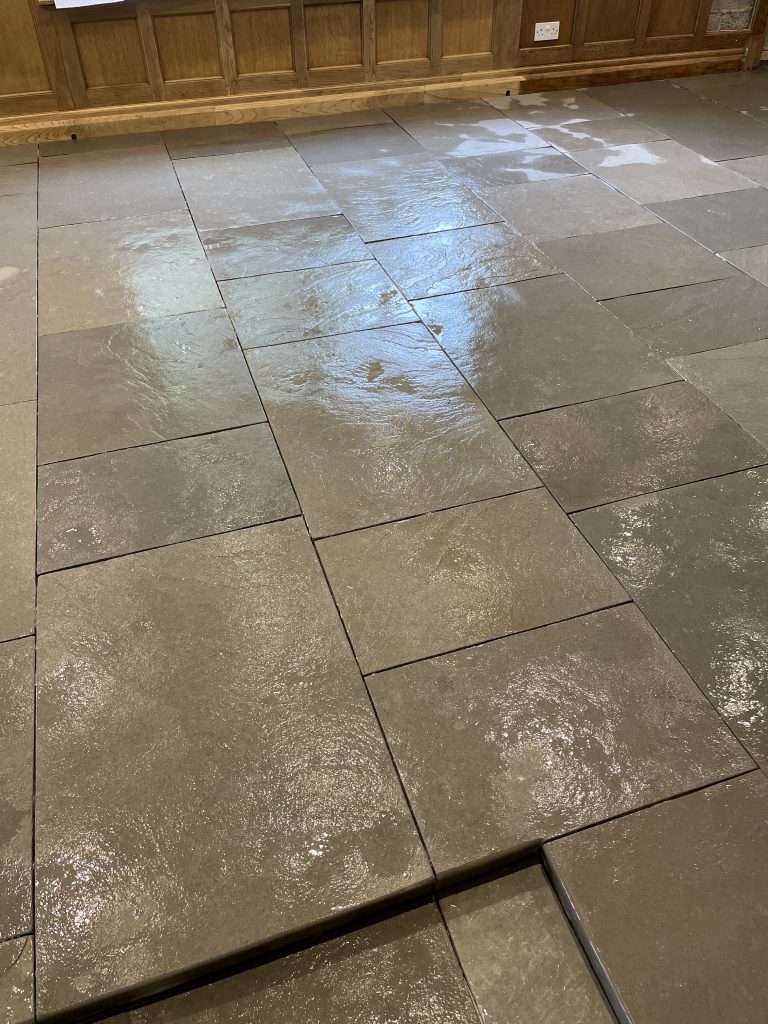 Ludlow Limestone main kitchen floor showing an ungrouted, freshly washed surface, with riven flagstone surfaces and step detail.