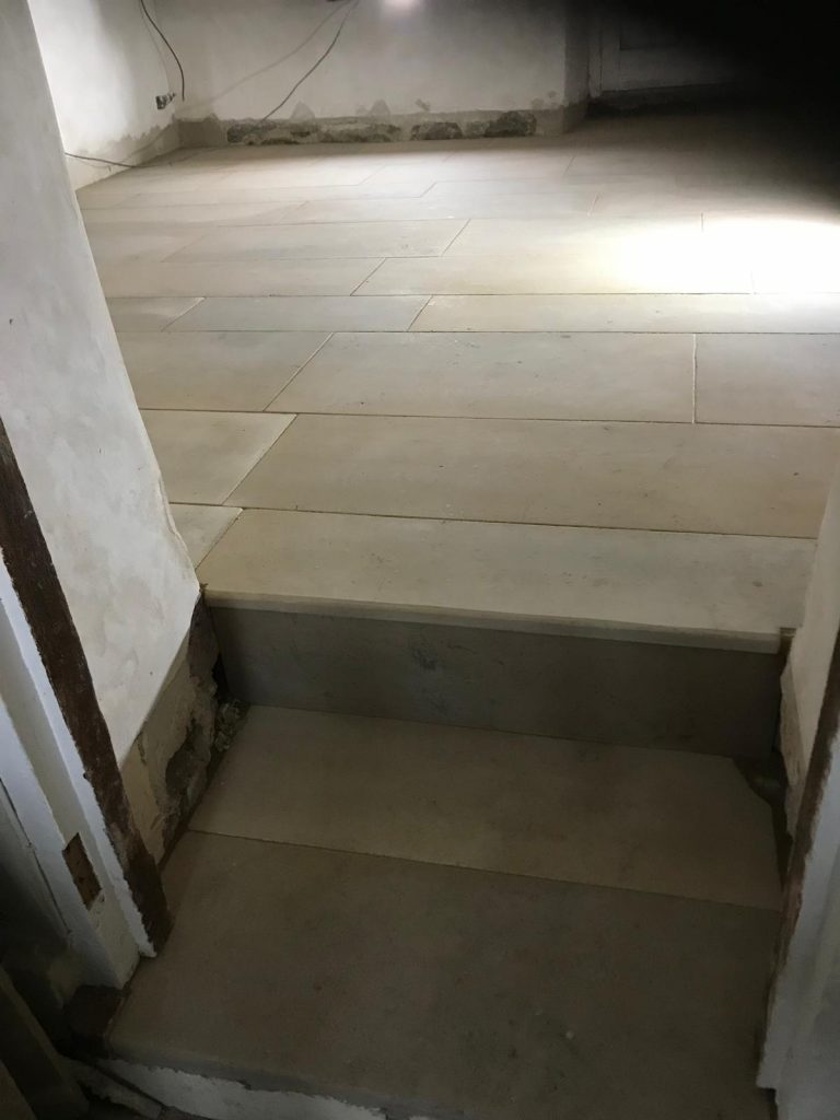 Marnhull Stone living room floor showing a slightly pillow edged stone and door step feature.