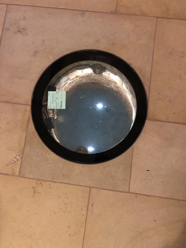 Marnhull limestone flooring showing an interior glass well lid surrounded by Marnhull stone showing fossil content. installed by Simali Stone