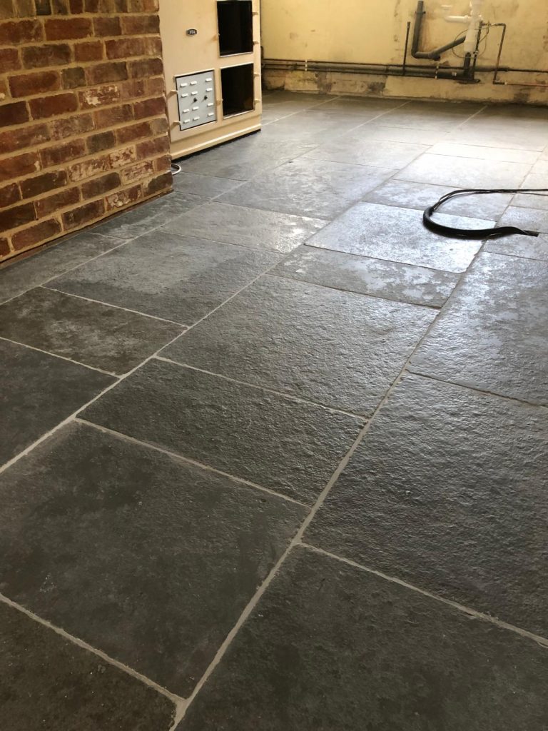 Southwell limestone flooring installed in random lengths showing classic grey tones and traditional flagstone character.