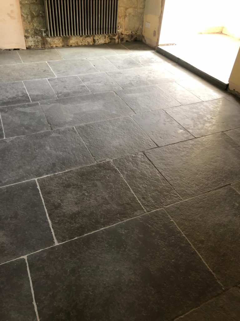 Southwell limestone floor showing random length stone tiles.