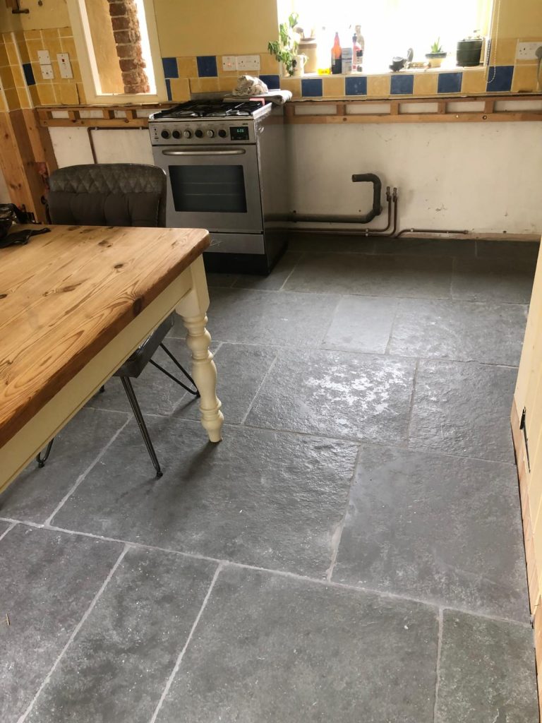Southwell limestone flooring installed in a kitchen in random lengths showing classic grey tones and traditional flagstone character.