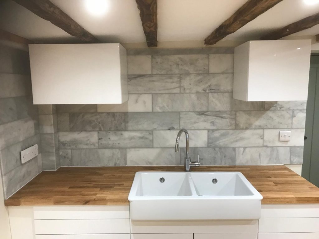 Marble decorative tiles as a sink splash in Wiltshire