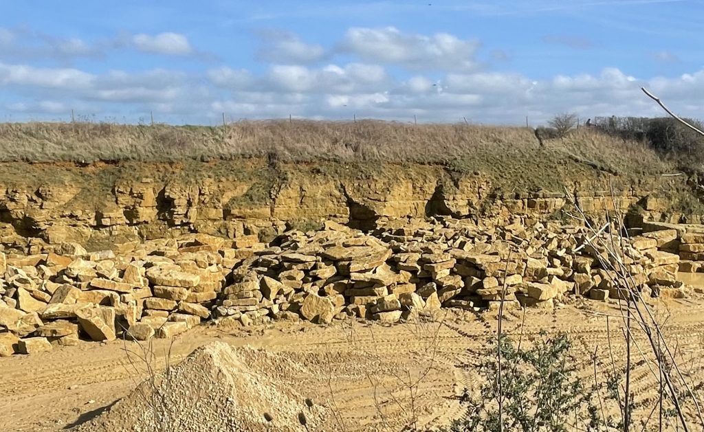 Stacked Marnhull stone slabs inside Dorset quarry