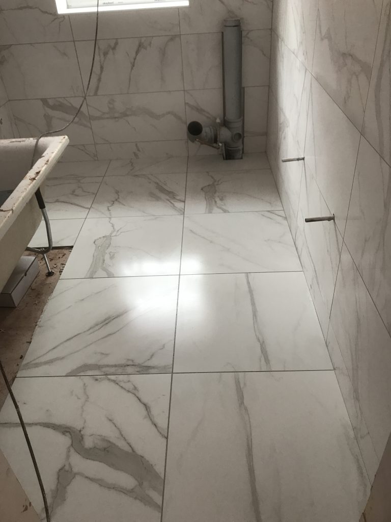 Carrara marble look alike porcelain bathroom floor.