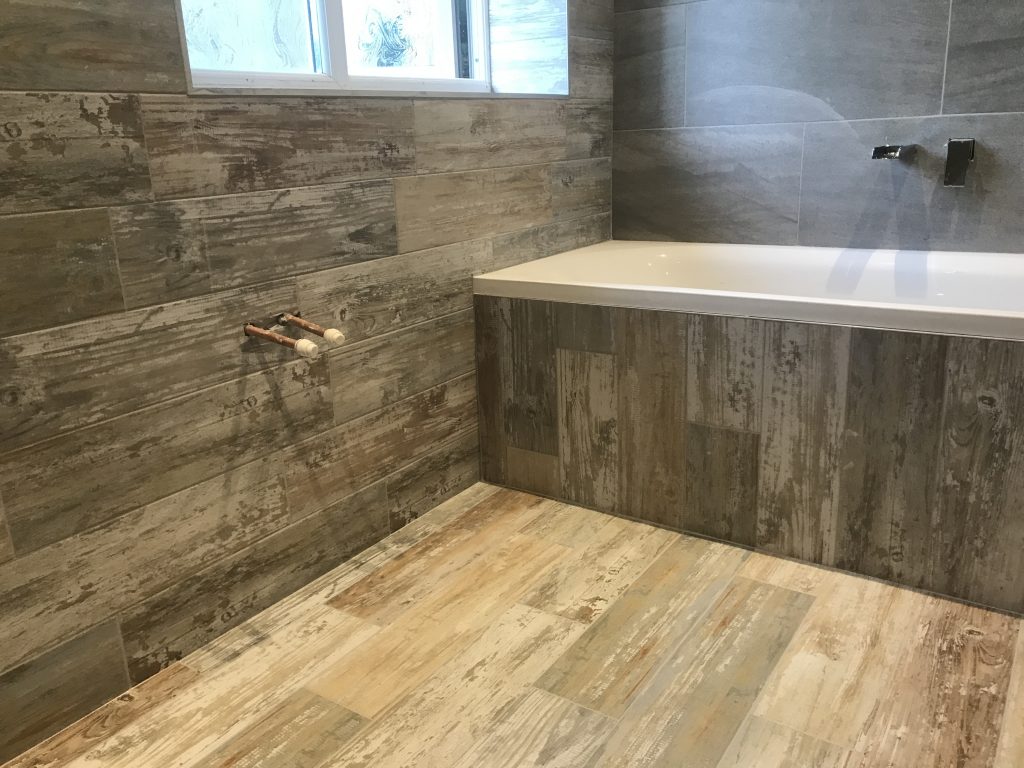 wood effect porcelain bathroom wall floor and bath panel installation Worcester