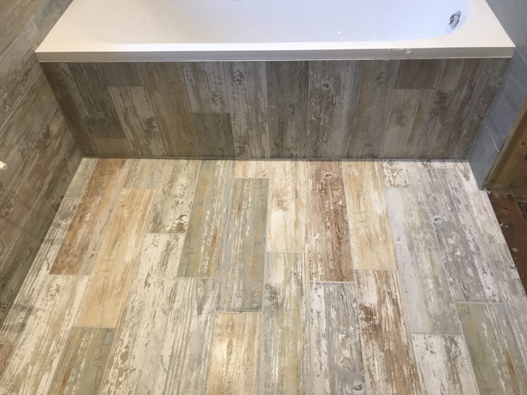 wood effect plank porcelain bathroom floor tiles bath panel and wall installation