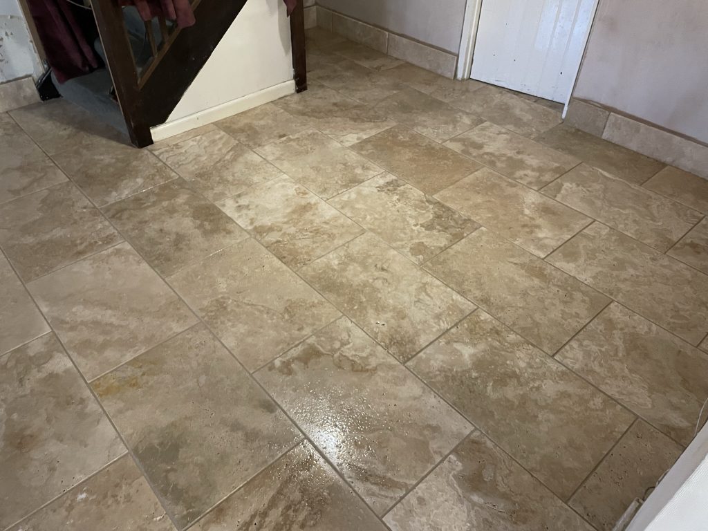 Living room floor tiled showing skirting boards in travertine tiles