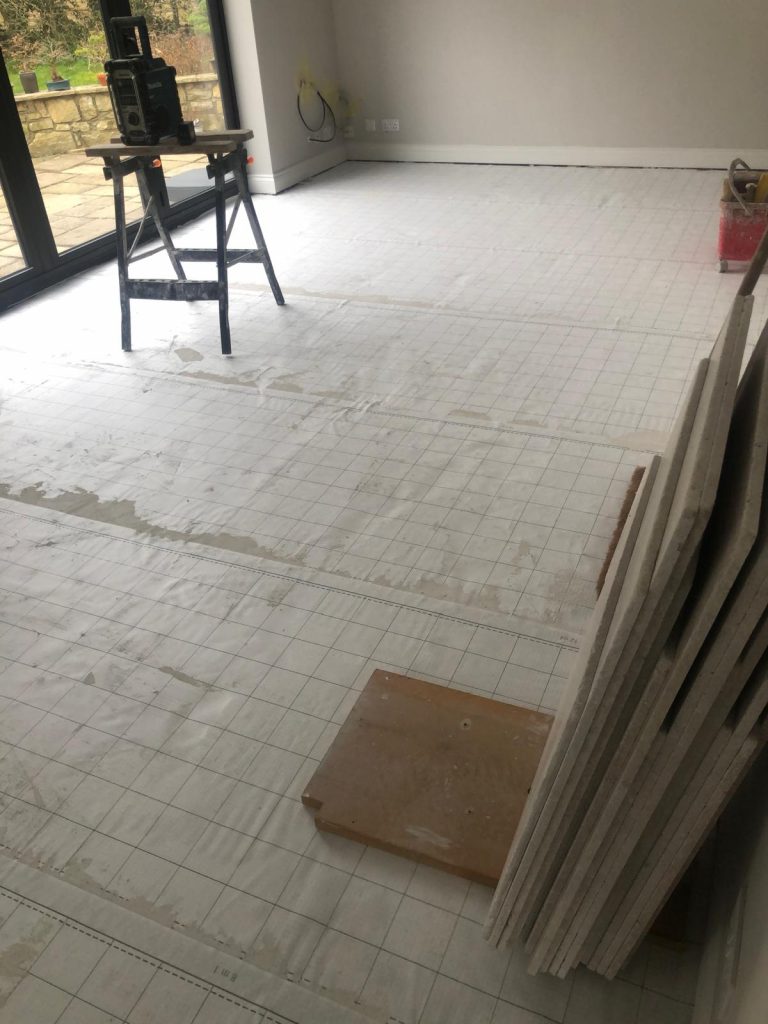 Kitchen tiling wincanton customers can see an Anti fracture mat installed prior to stone flooring.