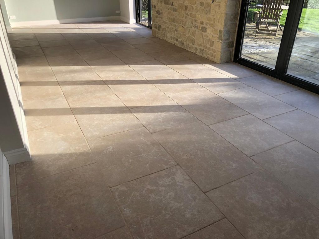 finished heritage limestone floor showing random length beige stone tiles.