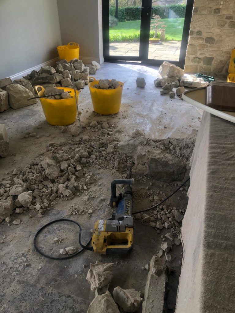 Tile flooring Dorset showing demolition of an old travertine floor 