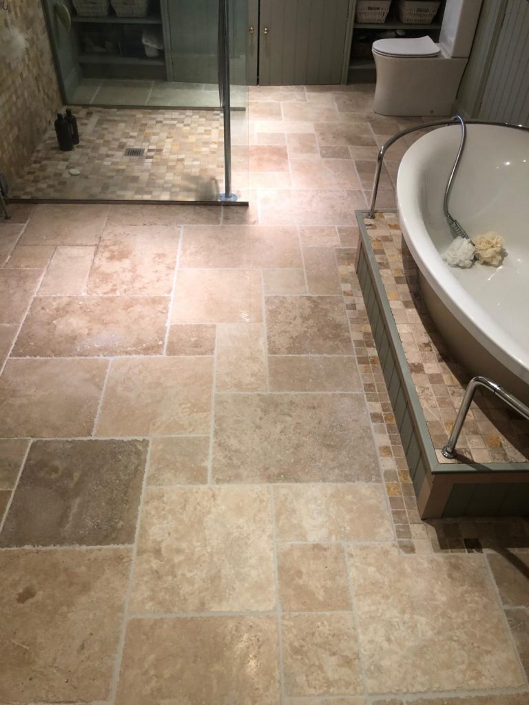 Long view of the bathroom floor showing the replaced tiles