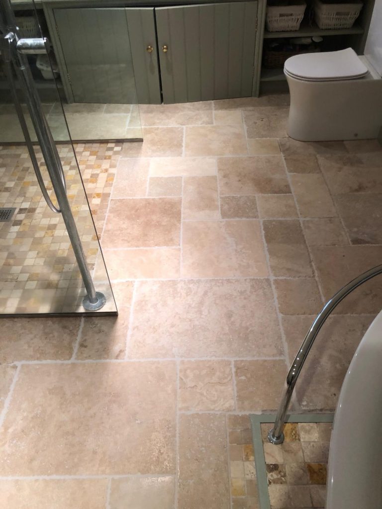 Close up view of the floor repaired with new travertine tiles