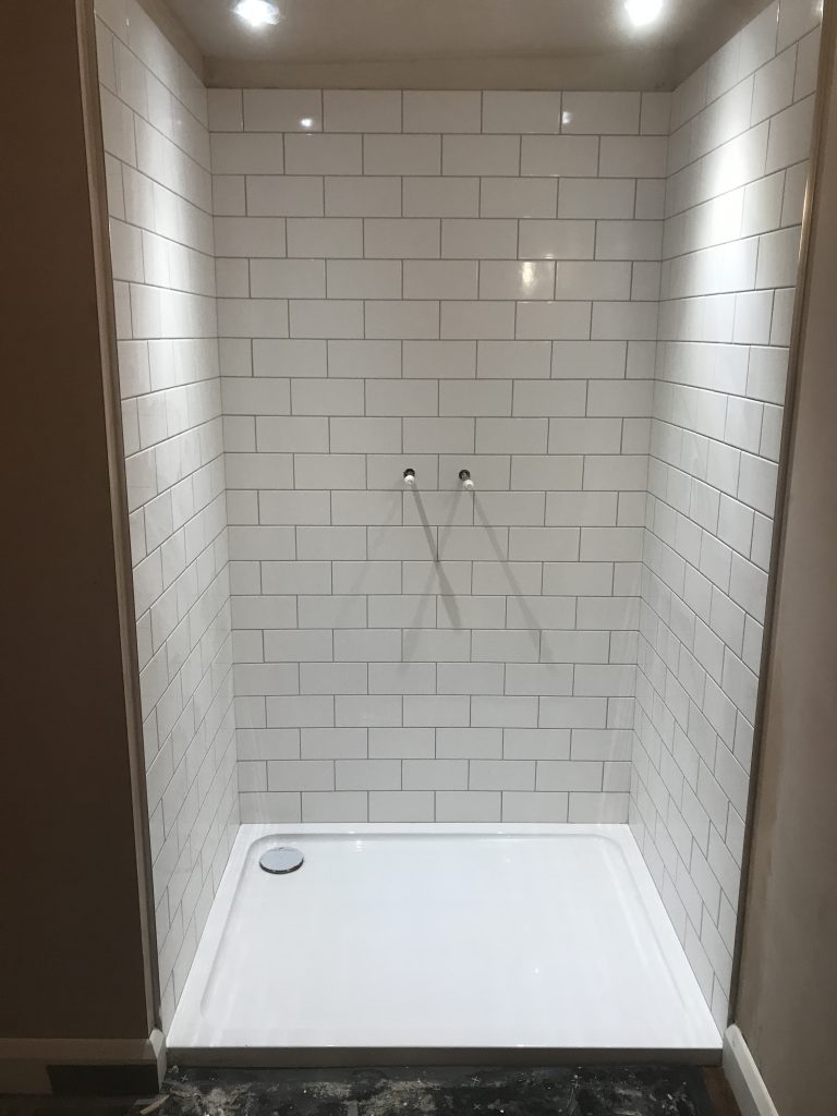 completed white ceramic bathroom wall tiles fully grouted in shower cubicle Worcester

