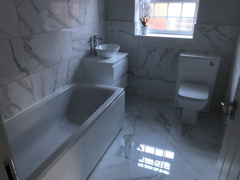 marble effect porcelain bathroom wall and floor tiles with bath and sink installation Worcester