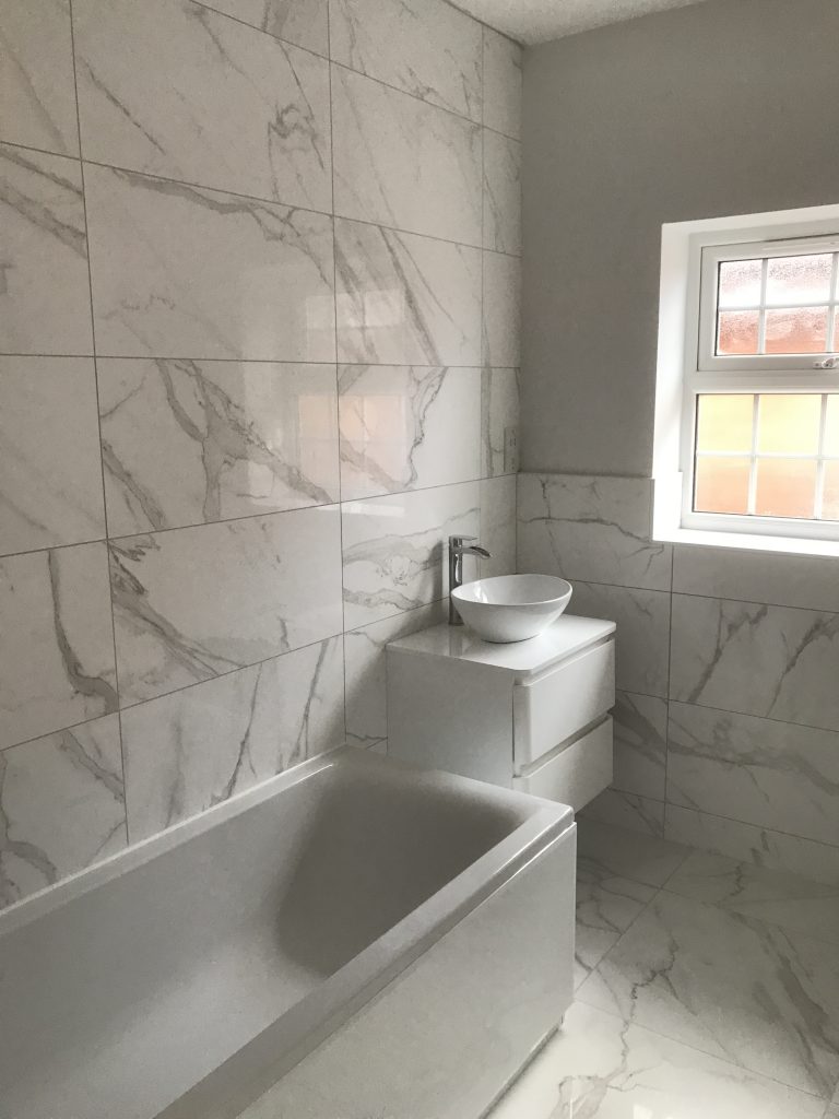 Carrara white marble lookalike porcelain tiles in a bathroom by Simali stone