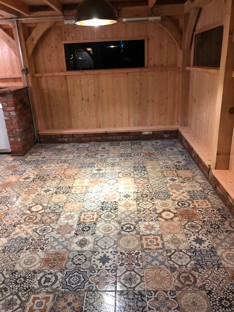 Decorative porcelain floor tiles installed in an outdoor garden extention in Sturminster newton